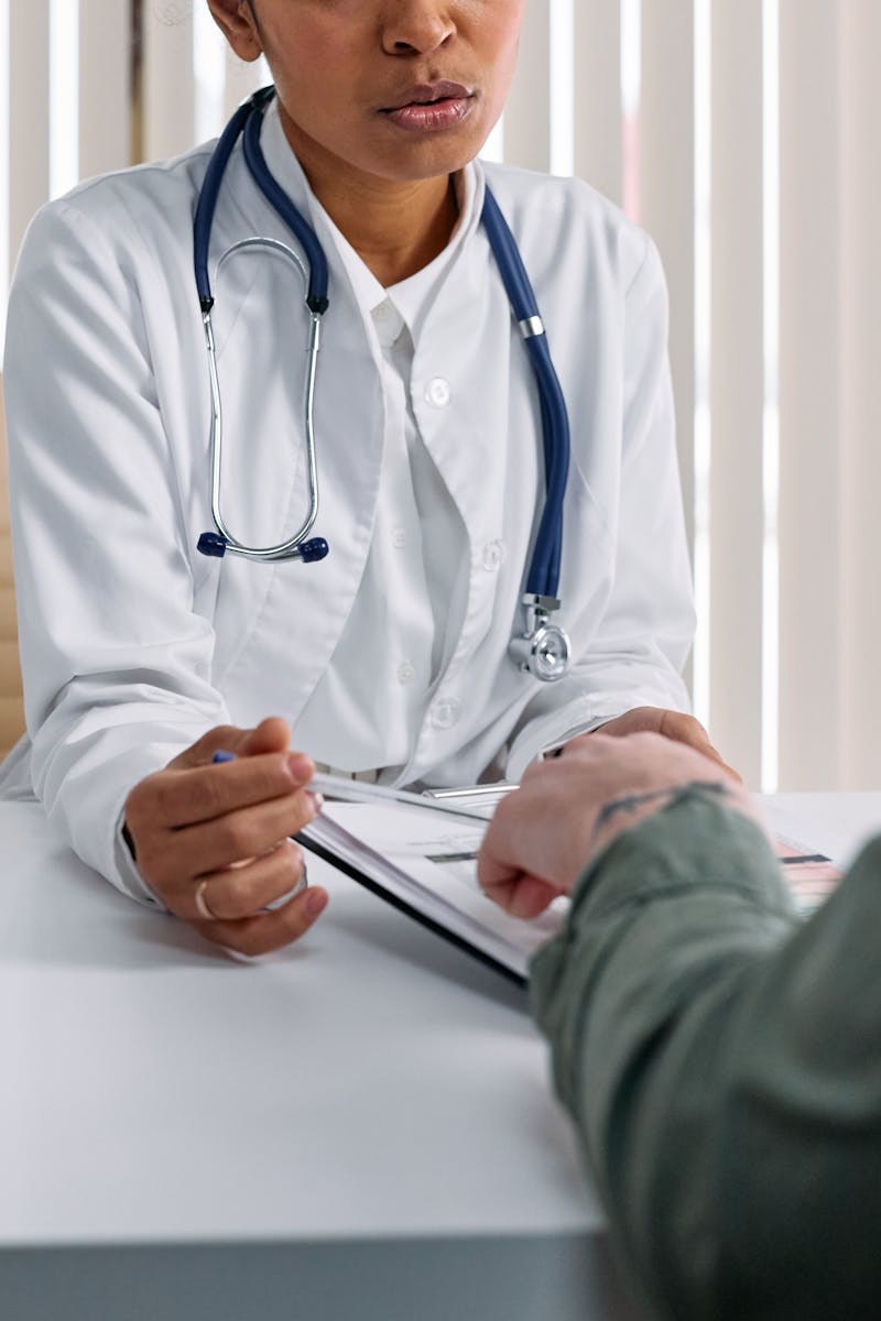 Doctor consulting with patient about health insurance enrollment options
