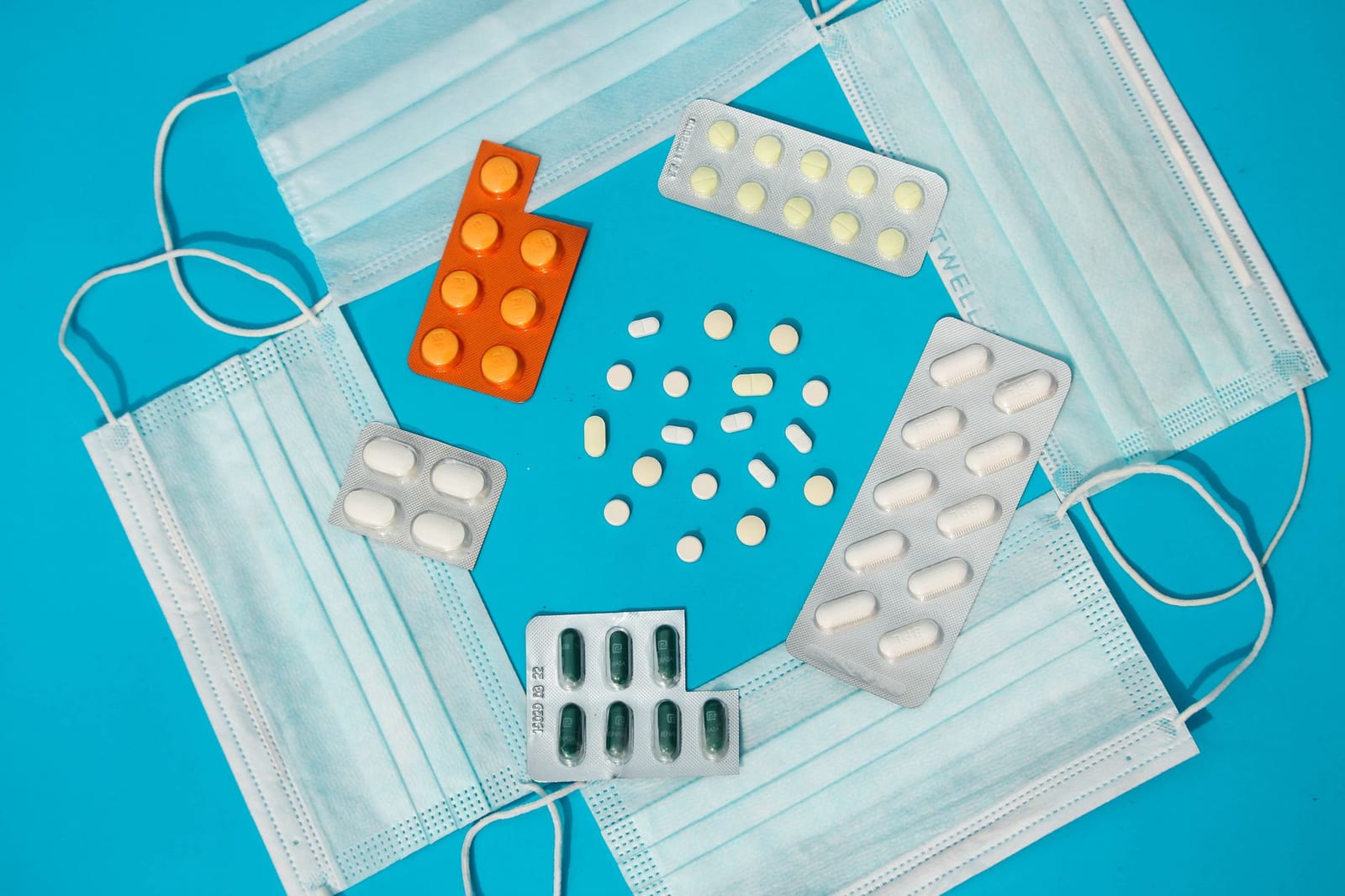 Top view of pills and masks symbolizes healthcare and protection. - Getting Started