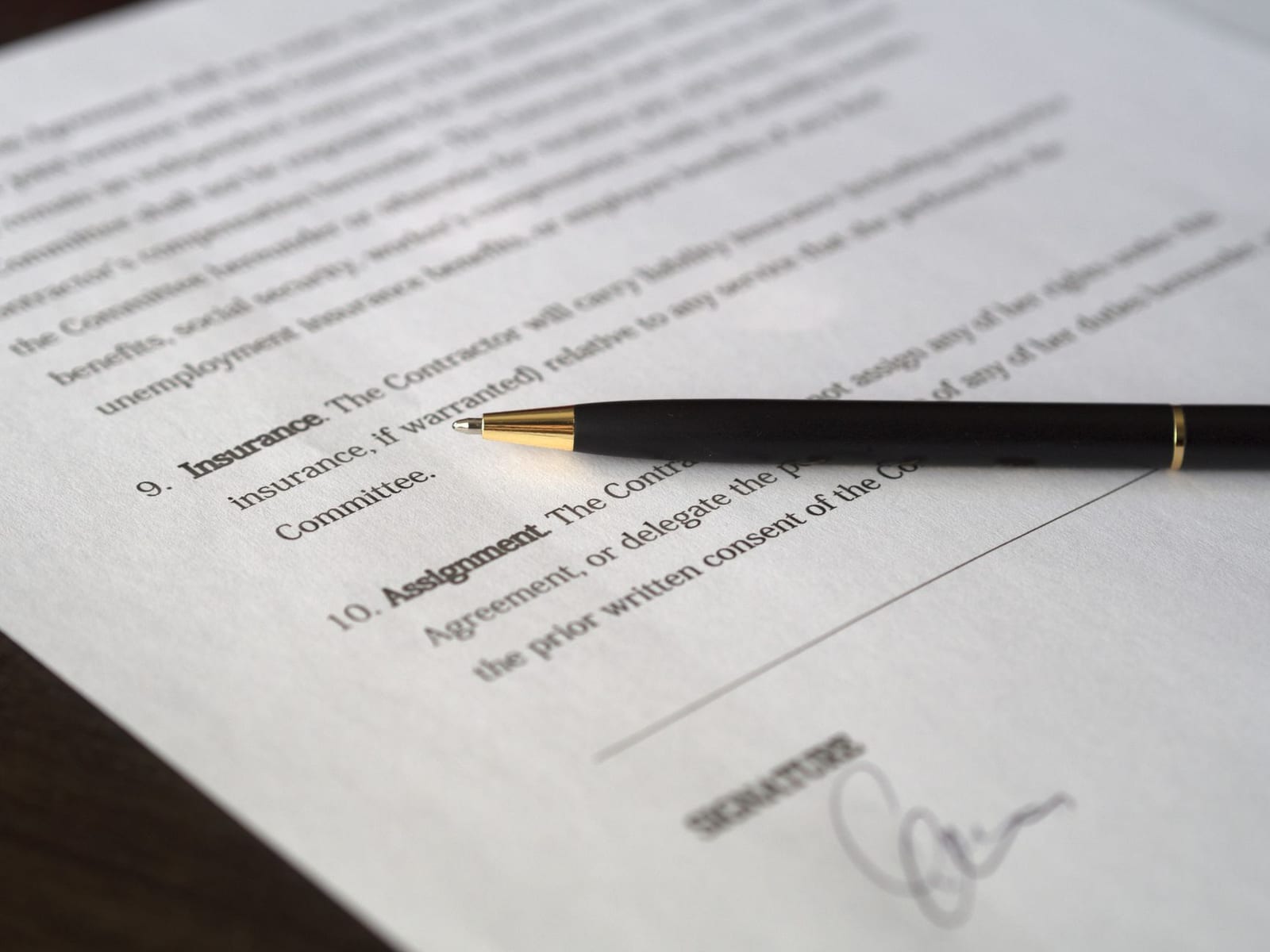 Close-up image of a business contract and pen, signed and ready for agreement. - Coverage for pre-existing conditions