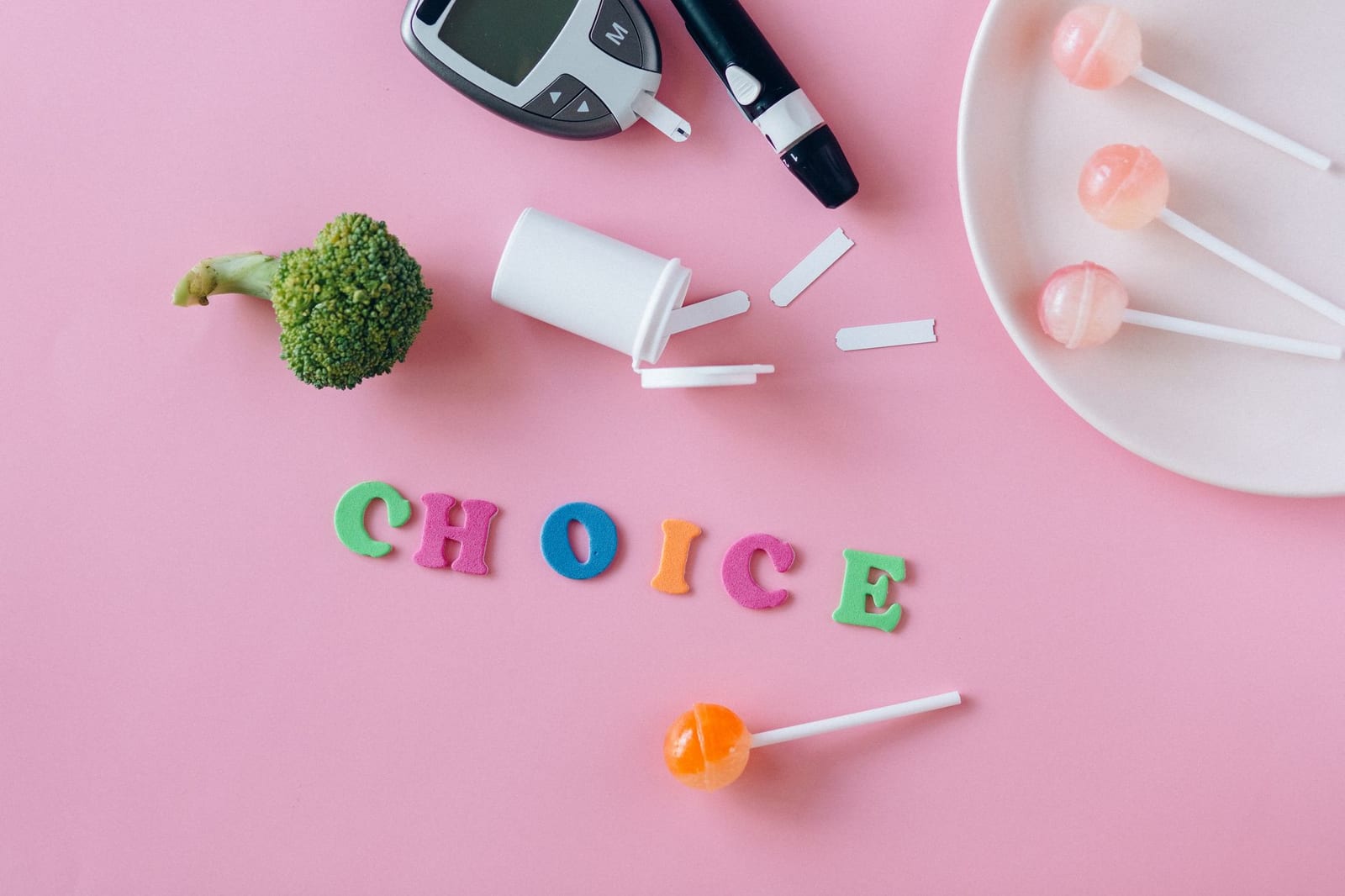 Conceptual image highlighting choice between health foods and sweets, symbolized by broccoli and lollipops. - When can you get health insurance?