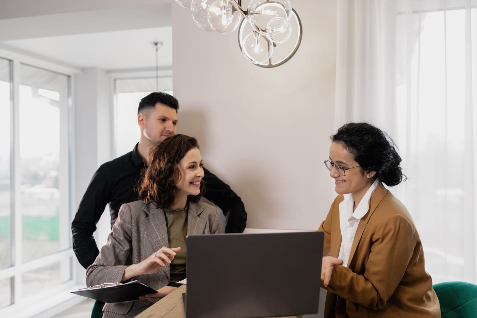Professional real estate discussion in modern office setting with consultants and clients. - Health insurance plan & network types: HMOs, PPOs, and more
