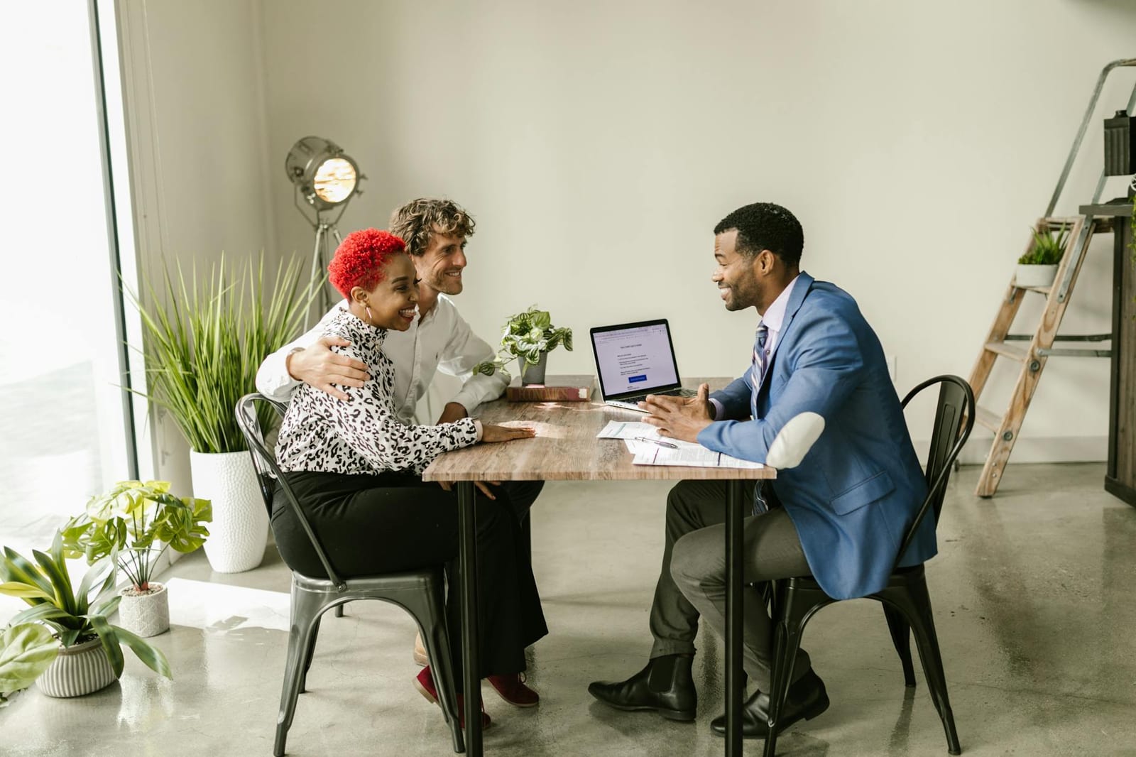 Three professionals in smart casual attire having a meeting in a modern office setting. - Other health coverage for 2024