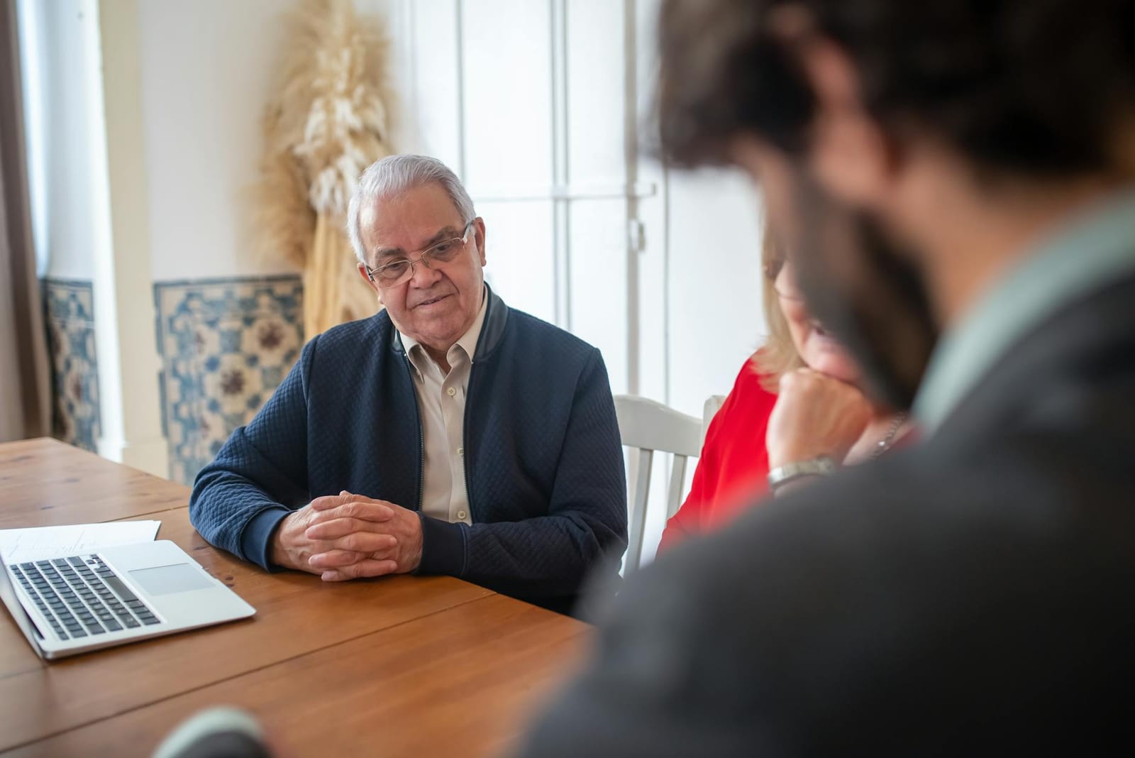 Senior man engaging with consultants at a business meeting indoors. - 2016 stand-alone dental plan (SADP) data