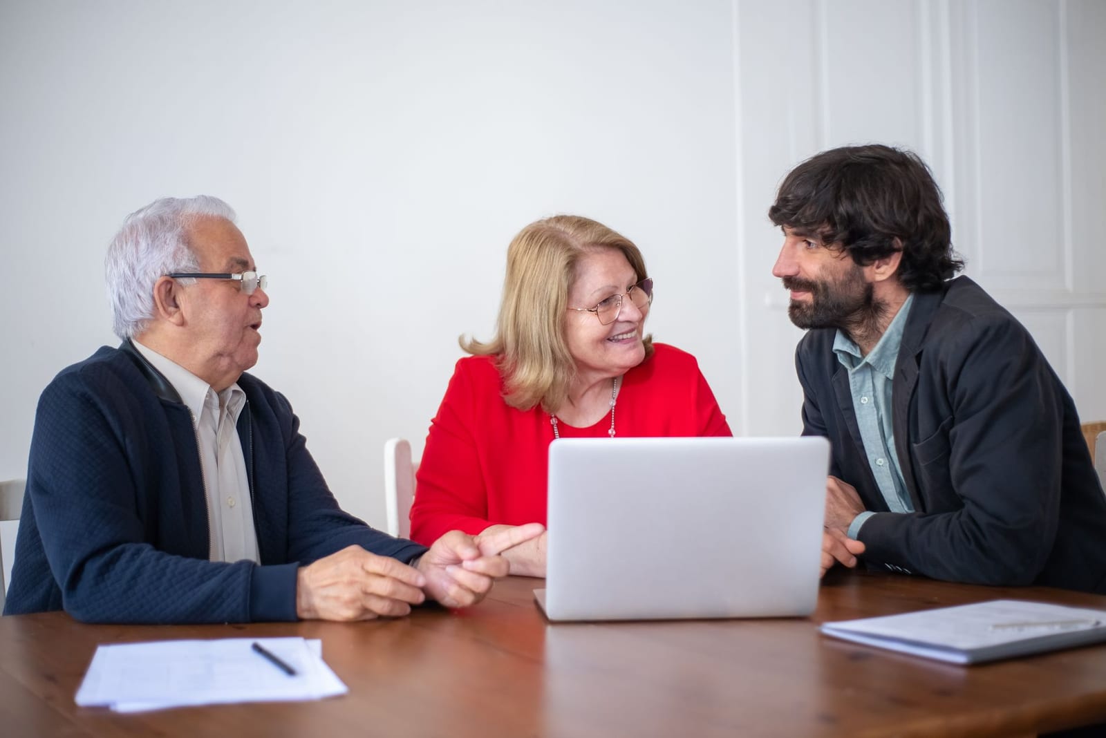 Elderly couple having a consultation with a professional advisor in a bright indoor setting. - Relationship questions