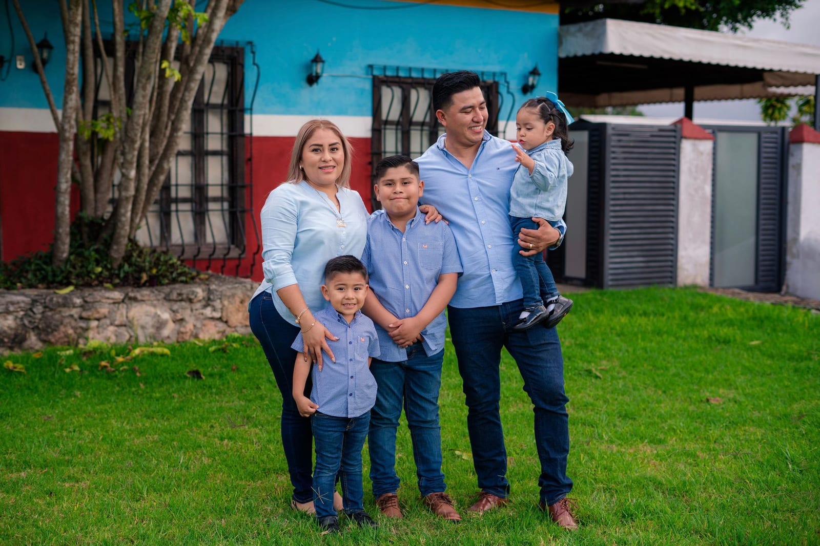 Candid family portrait outdoors with vibrant house background. - Medicaid expansion & what it means for you