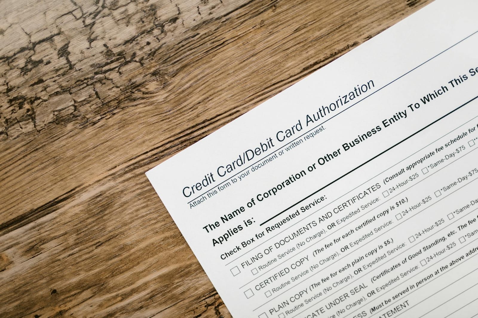 A credit card authorization form placed on a wooden desk, highlighting business paperwork essentials. - Income questions for American Indians & Alaska Natives