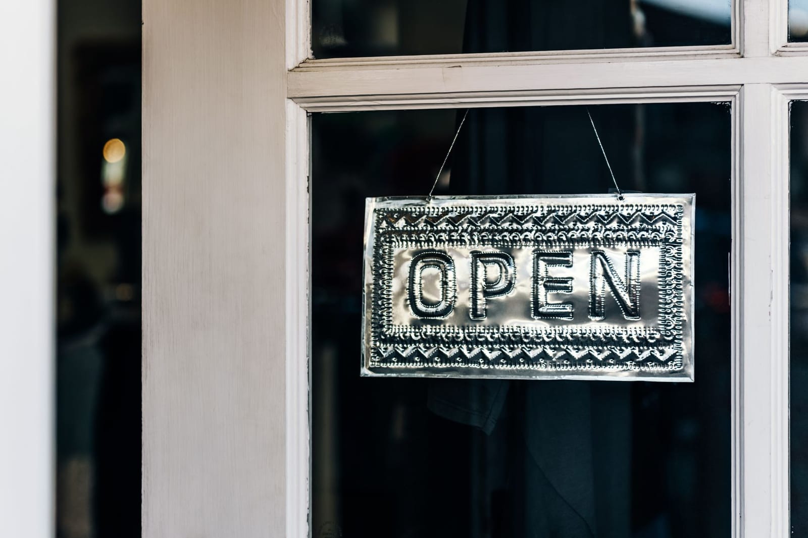 Metal open sign hanging on a shop door in Paso Robles, California. - New in 2026:  More plans now work with Health Savings Accounts