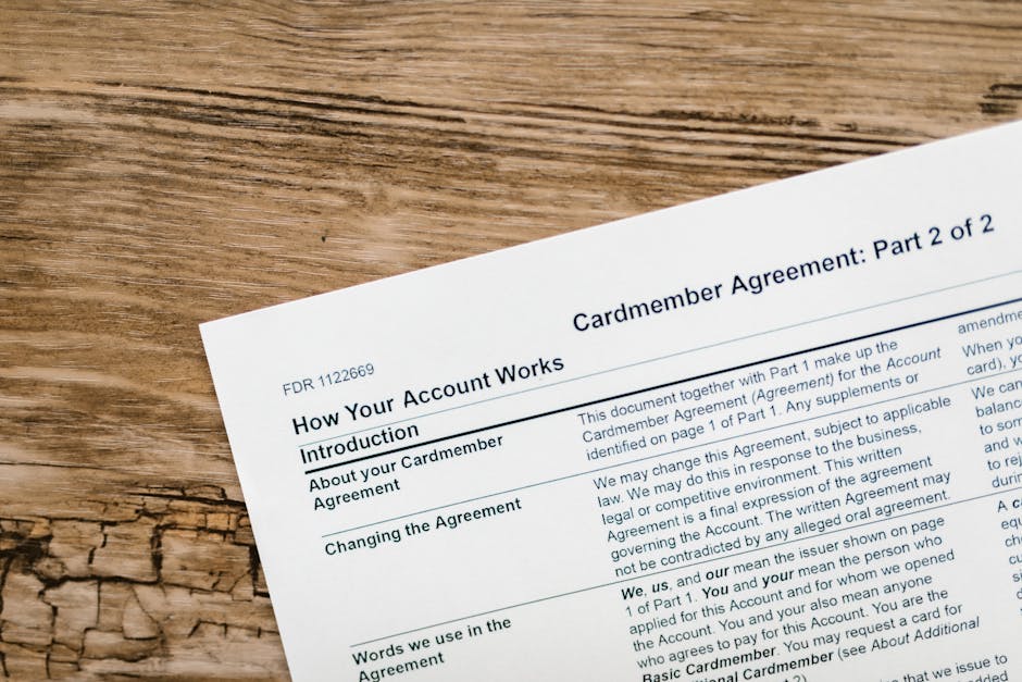 Close-up of a credit card agreement document on a textured wooden desk. health insurance