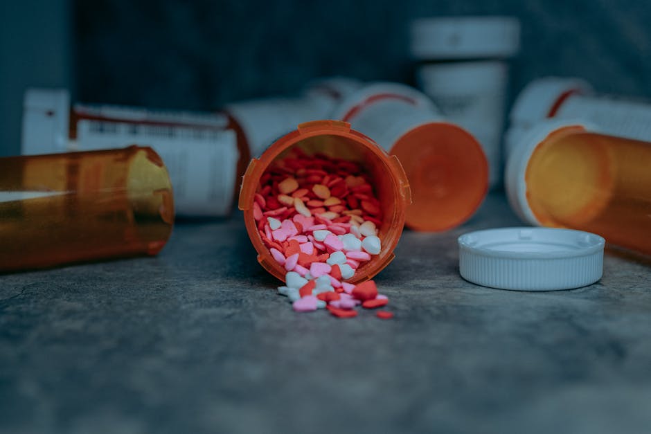 Colorful pills spilling from a prescription bottle on a counter in Portland, OR. health insurance