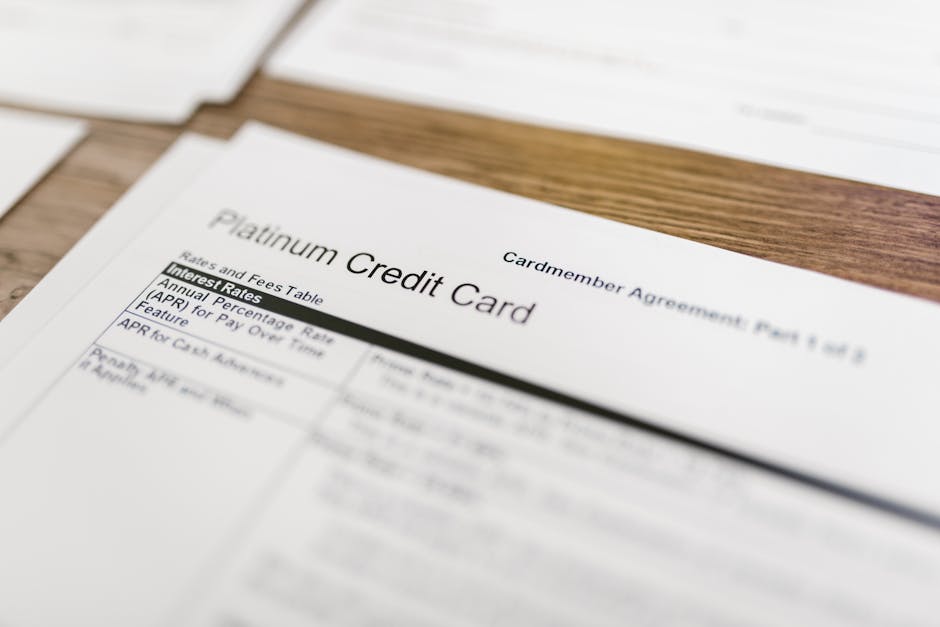 Close-up of a platinum credit card agreement document on a wooden desk. health insurance