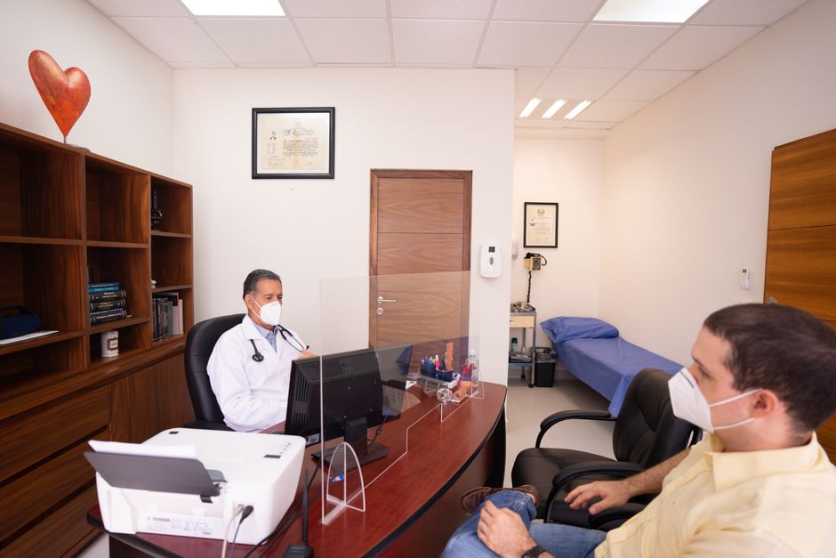 Doctor and patient with masks in medical clinic, emphasizing healthcare safety. health insurance