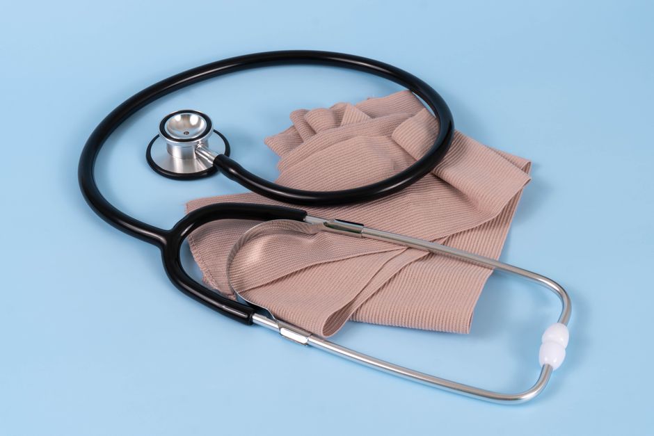 A stethoscope and bandage on a blue background, symbolizing healthcare and medical care. health insurance