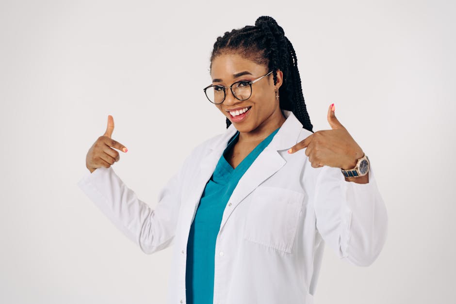 Smiling female doctor proudly pointing at her white lab coat. health insurance