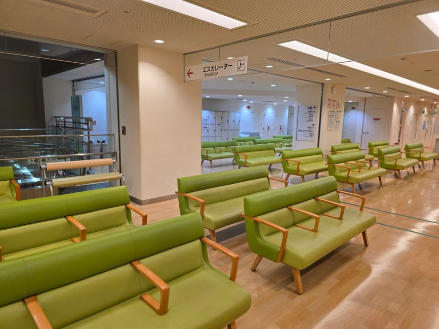 Empty hospital waiting area with green seats in Shibuya, Tokyo. health insurance