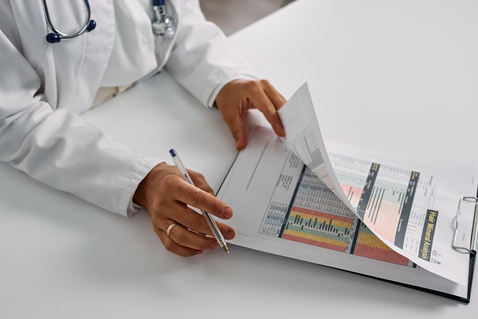 A medical professional checking patient reports with a clipboard in an office setting. health insurance