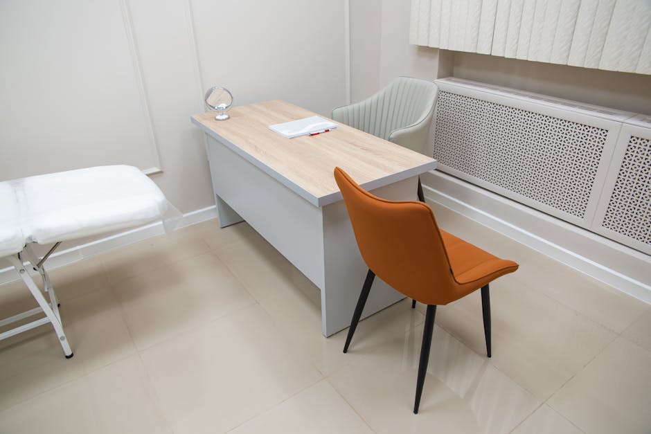 Minimalist office interior featuring a desk with chairs, suitable for healthcare or office settings. health insurance