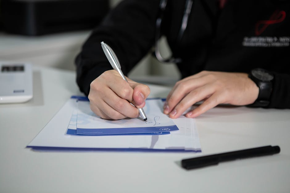 A doctor writing a prescription on paper with a ballpoint pen in a clinic setting. health insurance