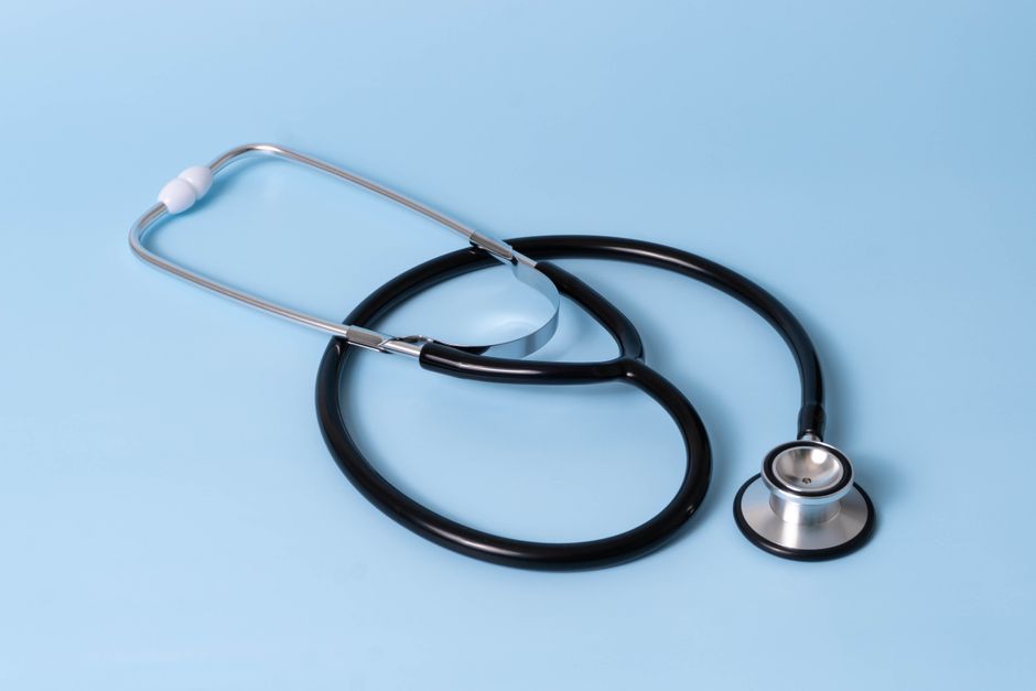 Close-up of a classic stethoscope on a blue background, symbolizing healthcare and medical profession. health insurance