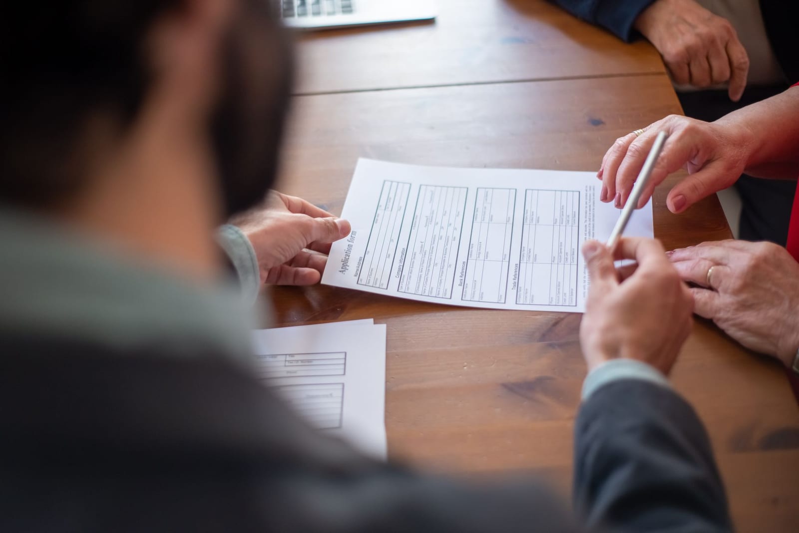 Close-up of business professionals reviewing documents at a meeting. health insurance
