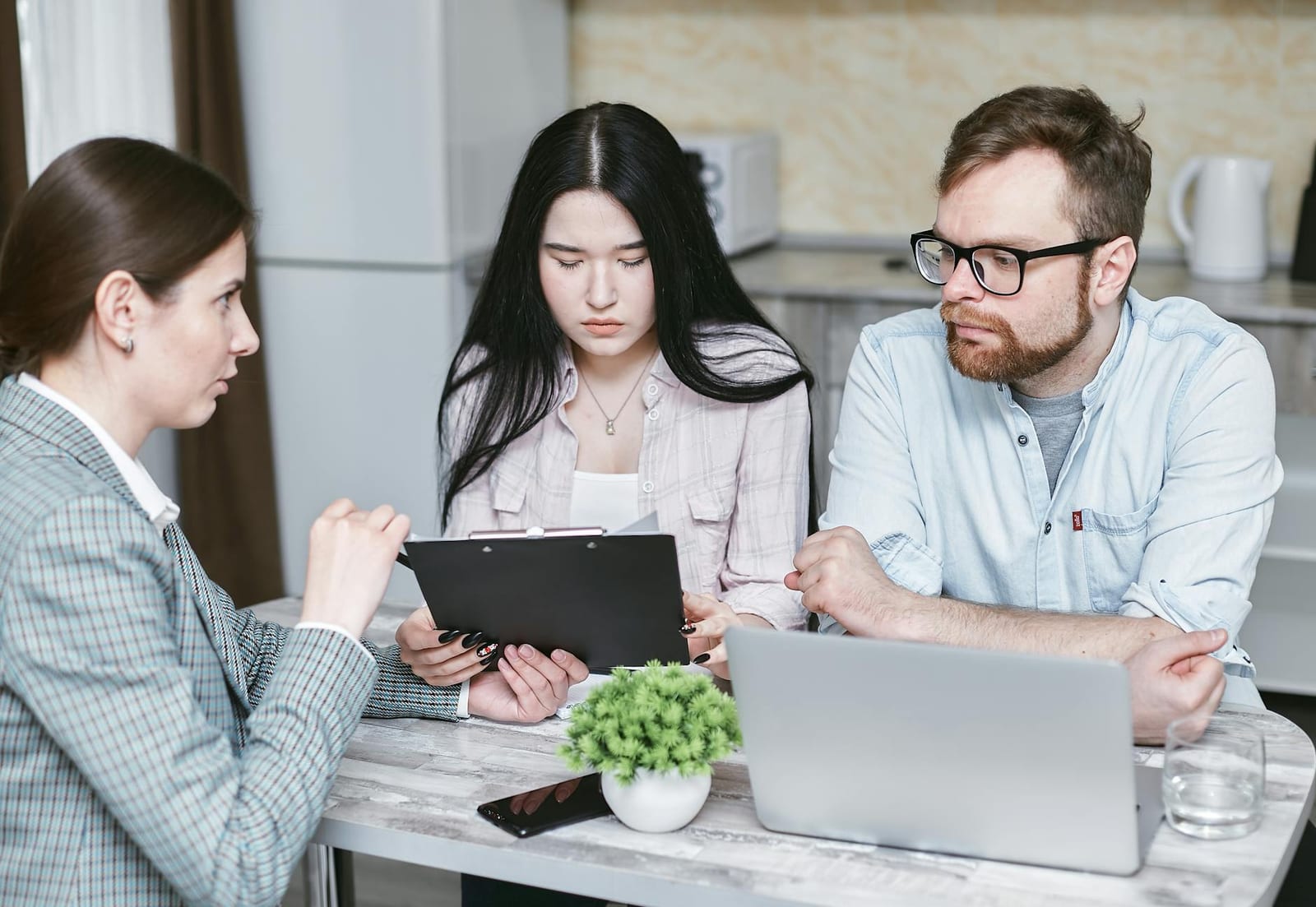 A group of professionals discussing business strategies at a table indoors. health insurance
