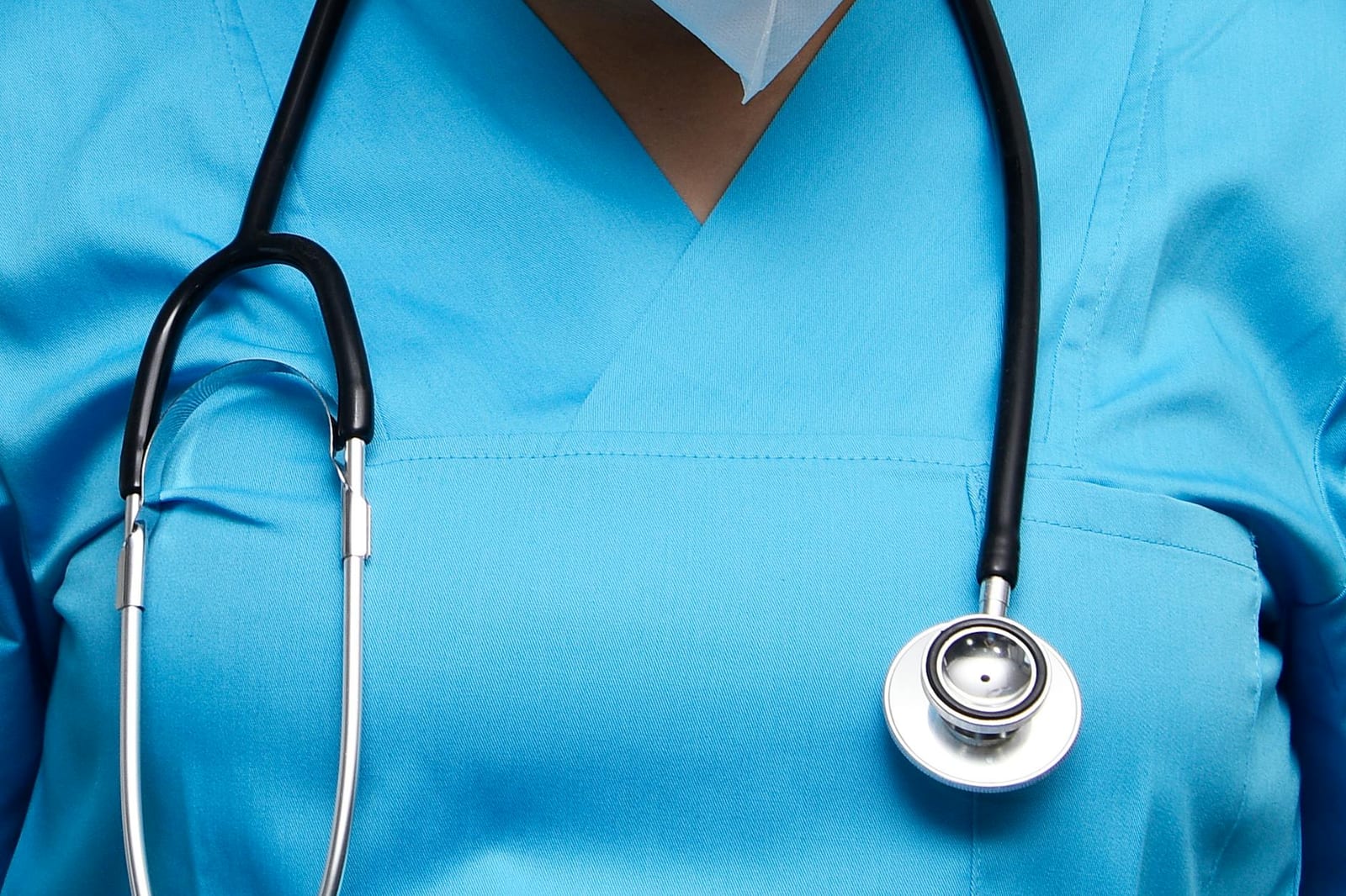 Detailed image of a medical professional wearing scrubs and a stethoscope, symbolizing healthcare. health insurance